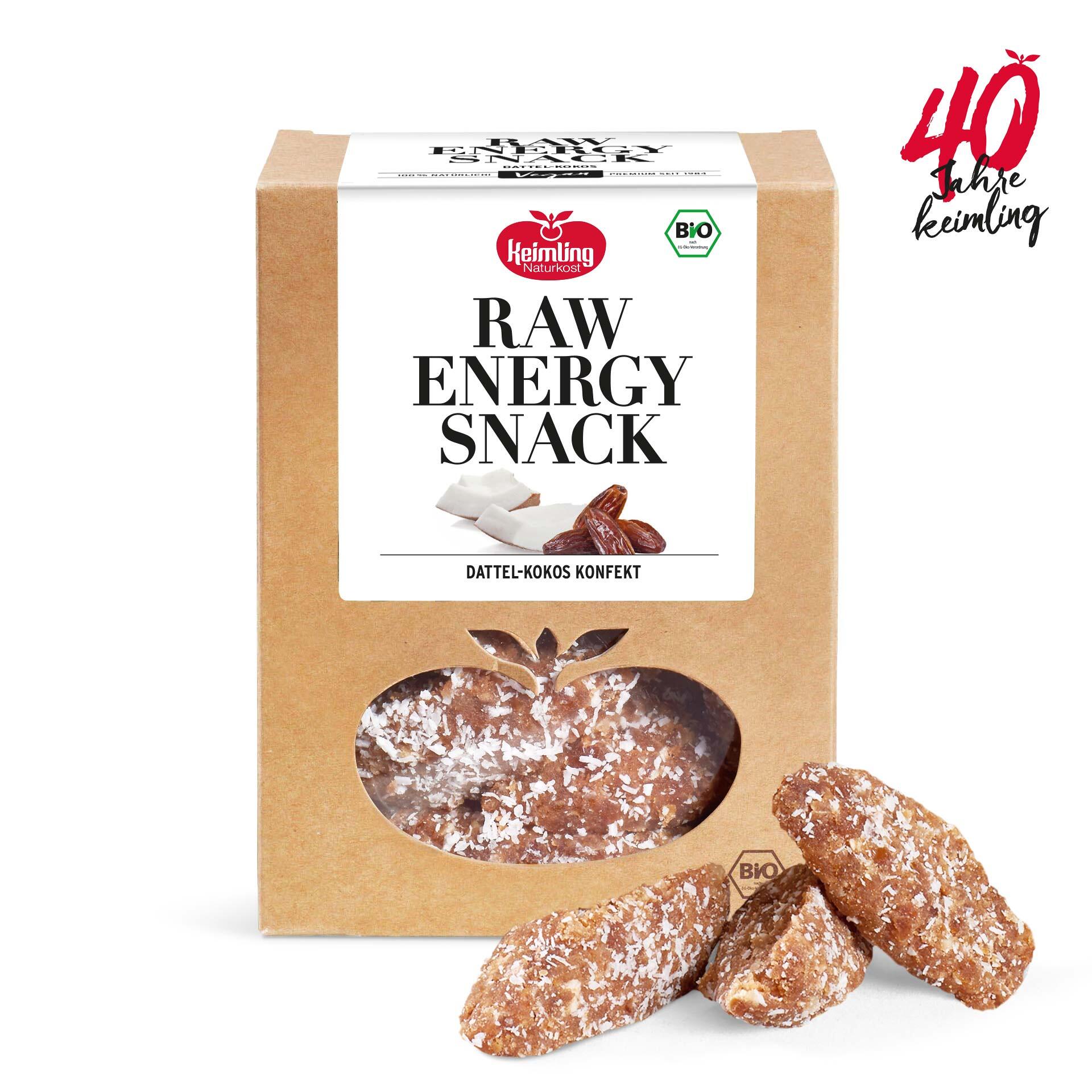 Die Packung zeigt Keimling Naturkost Raw Energy Snack Dattel-Kokos Konfekt in Bio-Qualität. Drei Stücke sind vor der Verpackung zu sehen, mit Kokosraspeln bestreut.