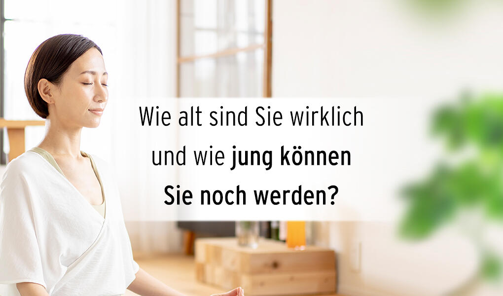 Frau sitzt mit geschlossenen Augen entspannt in einem hellen Raum. Neben ihr steht der Text Wie alt sind Sie wirklich und wie jung können Sie noch werden? in schwarzer Schrift.