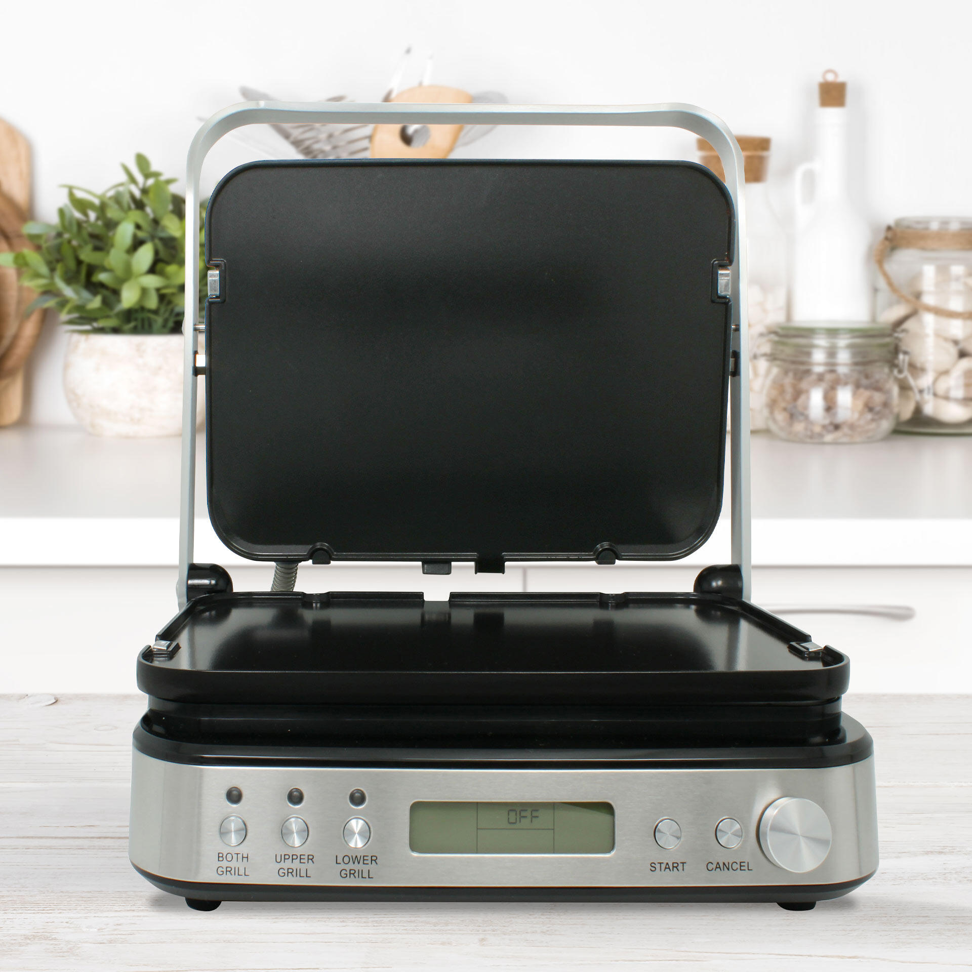 Elektrischer Tischgrill mit geöffnetem Deckel und Edelstahlgehäuse. Display zeigt OFF. Bedienelemente mit Knöpfen für BOTH GRILL, UPPER GRILL, LOWER GRILL, START und CANCEL.