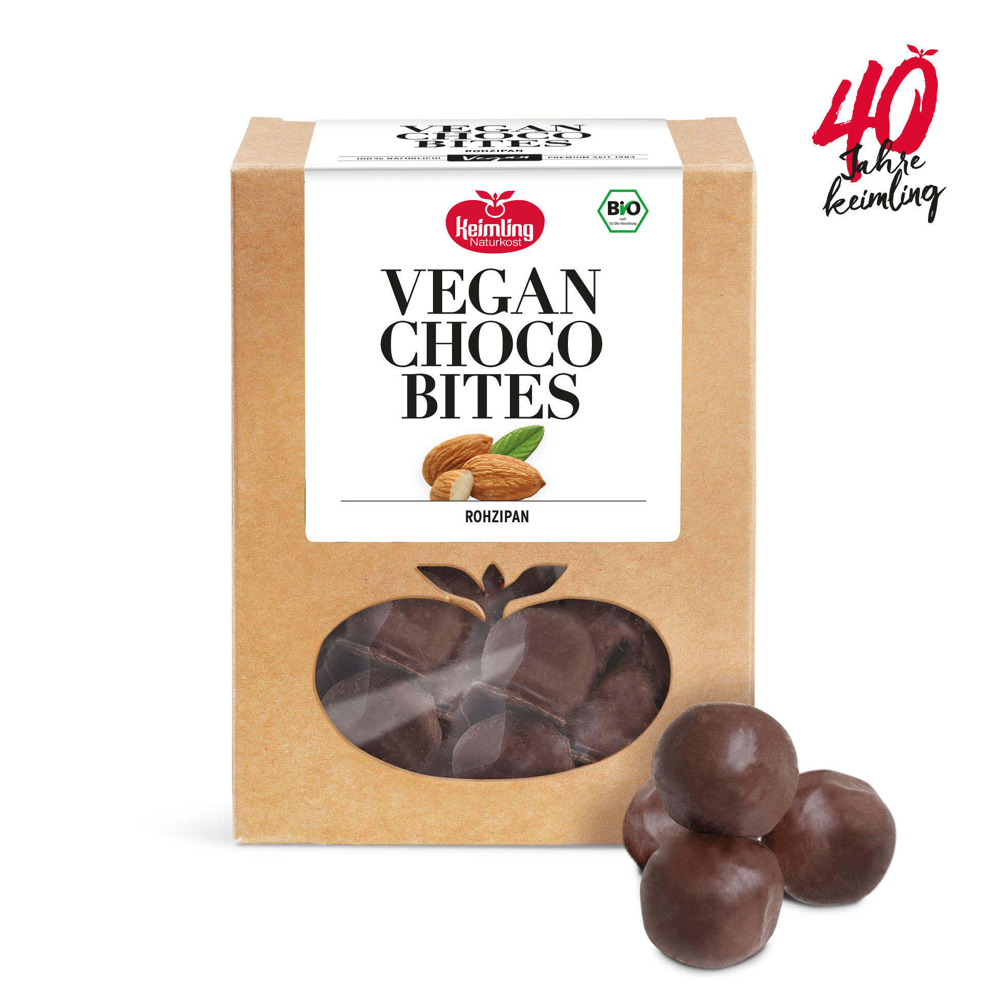 Verpackung mit der Aufschrift Vegan Choco Bites Rohzipan von Keimling Naturkost. Vier runde Schoko-Bonbons liegen vor der Verpackung. Bio-Siegel und 40 Jahre Keimling Schriftzug sind sichtbar.